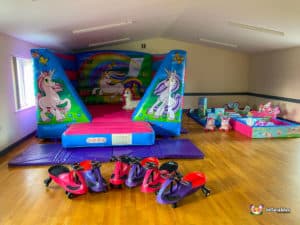 Low bouncy castle with unicorn theme and plasma cars and unicorn soft play.