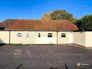 Building with car Parkin g space outside.