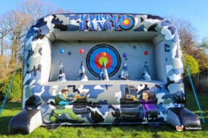 An inflatable target range shootout featuring colourful targets and camouflage design, set outdoors on a sunny day.