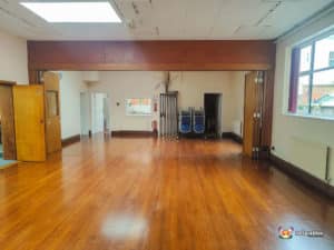 venue with low roof and hardwood floors.