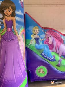 Inflatable princess castle with unicorn design, featuring vibrant colors and a fun bouncy area for children to play.