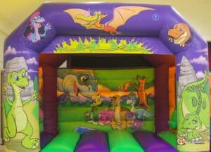4. Brightly colored bouncy castle showcasing friendly dinosaurs and animals.
