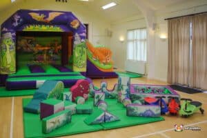 A fun themed bouncy castle with soft play package in matching dinosaur themed.