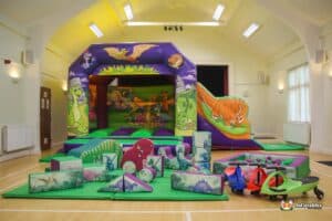 A colorful bouncy castle indoors and multiple toys, designed for children's playtime activities.