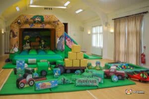 Play area for children with a farm theme, including a bounce and slide for active play.