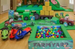 Children's farmyard play area featuring a bounce and slide for outdoor fun and exploration.