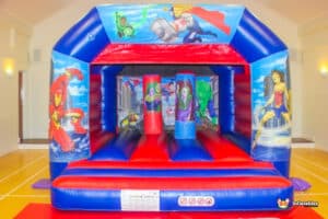 A bouncy castle featuring a superhero theme, called "Hero Biff and Bash," with bright colors and fun designs for kids.