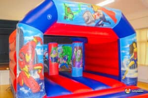 A playful bouncy castle named "Hero Biff and Bash," showcasing a superhero theme with lively colors and graphics.
