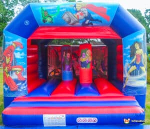A lively bouncy castle adorned with superhero imagery, designed for kids to enjoy jumping and playing in a fun environment.