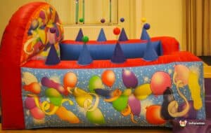 A playful bouncy castle embellished with colorful balloons and decorations, designed for children's enjoyment and celebration.