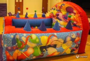 A lively bouncy castle decorated with balloons and various ornaments, perfect for a fun-filled children's party.