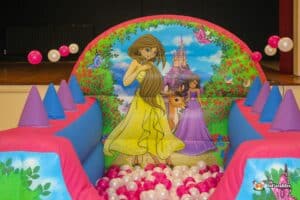 A vibrant princess castle play structure adorned with princesses, featuring a ball pool for children to enjoy.