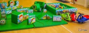 A vibrant soft play area filled with toys and a ball pit, perfect for kids to explore and have fun in a safe environment.