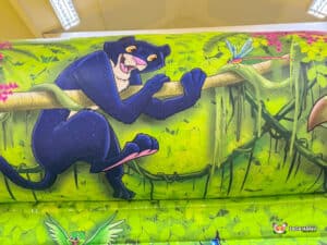 Jungle-themed bouncy castle featuring vibrant colors and animal designs.