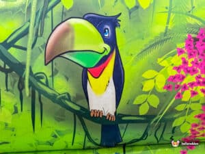 A vibrant bouncy castle featuring a jungle theme, complete with animal illustrations