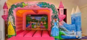 A colorful princess castle bouncer featuring a slide and turret, designed for children's play and entertainment.