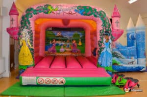 A vibrant princess castle bouncer with a slide, designed for fun and entertainment at children's parties.