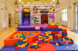 A playful castle area showcasing a bouncy castle and a slide, designed for children's entertainment and fun.