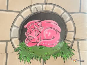 A vibrant inflatable dragon with a red head, Sleeping.