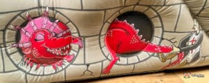 A large inflatable dragon in red hiding.
