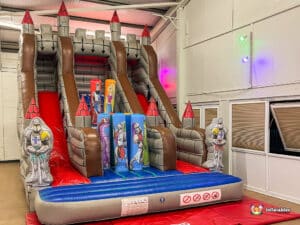 slide with a medieval art work, showcasing a castle on top where children can climb and slide down.