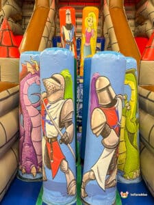 A playful castle slide featuring a medieval castle at the top, designed for children to climb and slide down joyfully.