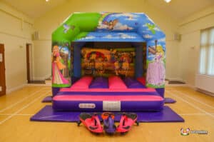 A colorful bouncy castle featuring princesses, labeled as "Princess Bouncer," inviting children to play and have fun.