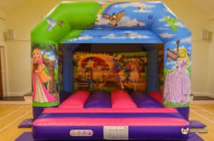 A vibrant bouncy castle adorned with princess graphics, named "Princess Bouncer," designed for children's entertainment.