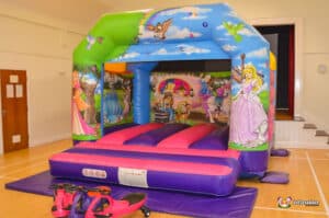 A lively bouncy castle featuring princesses, known as "Princess Bouncer," providing a joyful play experience for children.