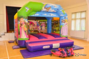 A whimsical bouncy castle showcasing princesses, titled "Princess Bouncer," perfect for children's parties and events.