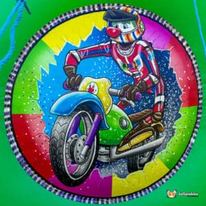 A colorful illustration of a clown riding a motorcycle, set against a vibrant background of splashes in various hues.