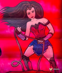 A vibrant illustration of a warrior woman in a red and blue outfit, confidently wielding a lasso against a bright pink background.