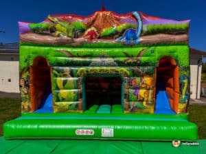 A colorful dinosaur-themed dinosaur double slide cabin featuring cartoon dinosaurs, explorers, and lush greenery, set against a blue sky.