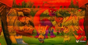 A vibrant inflatable play area featuring children playing with animated dinosaurs and exploring nature, set in a colorful landscape.