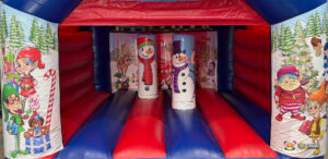 Close-up front view of the inflatable bouncy castle interior, showing two snowman-themed inflatable pillars and cartoon elf artwork on the vertical panels