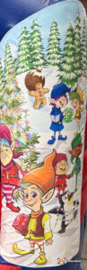 Close-up side art of the bouncy castle featuring a group of five colorful cartoon elves in a snowy scene with Christmas trees, a gingerbread man, and a Christmas pudding.