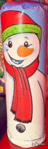 Vertical close-up of one of the internal inflatable pillars, featuring a smiling snowman with a carrot nose and a red and green hat and scarf.