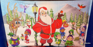 Large back wall artwork panel from the bouncy castle, featuring a snowy scene with a prominent Santa Claus standing next to a gas lamp, surrounded by reindeer and playful elves.