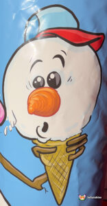 Close-up artwork of a snowman's head in a baseball cap, looking surprised as its body melts into an ice cream cone.