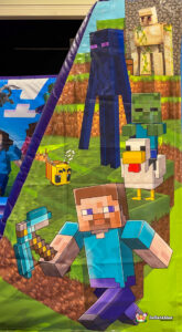 Vertical close-up of the right column artwork, featuring blocky Minecraft characters: Steve holding a pickaxe, an Enderman, a Bee, and a Zombie riding a Chicken on a grassy landscape.