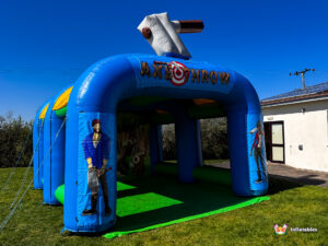 An angled outdoor shot of the blue and yellow inflatable arena, showing the character pillars and the depth of the unit.