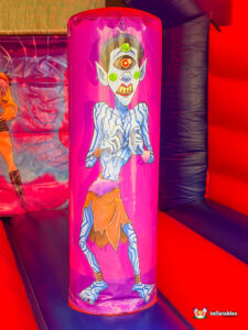 Close-up of a vertical biff-bash obstacle printed with a blue one-eyed monster.