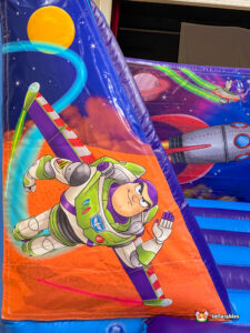 A vertical close-up of the left-side pillar artwork featuring the character Buzz Lightyear flying through space.